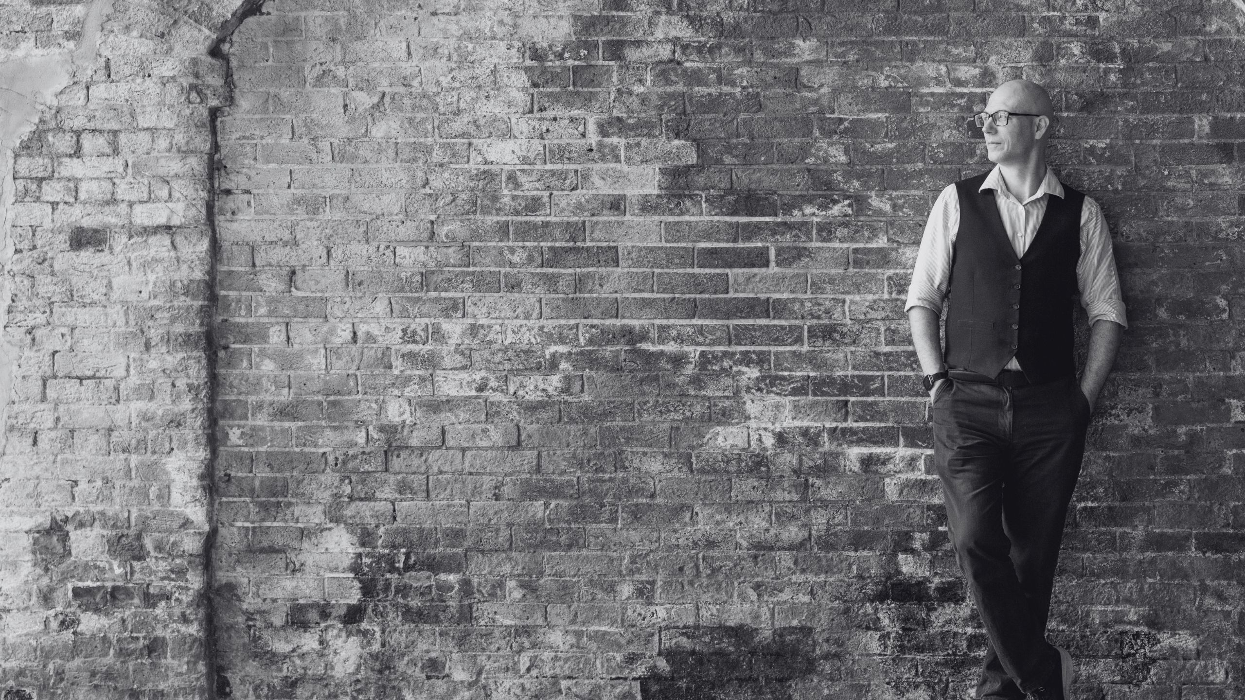 David Ross, WordPress Specialist, leaning against a brick wall